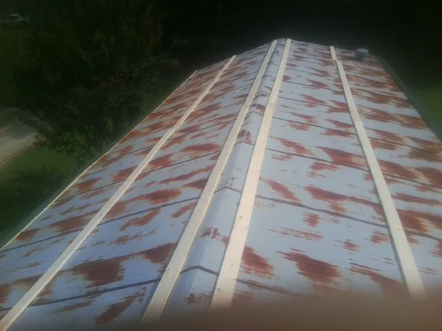 Rusted metal roof panels with new wood purlins before replacement — Storm Damage Roof Repair in Hope Valley by Roofing Brothers