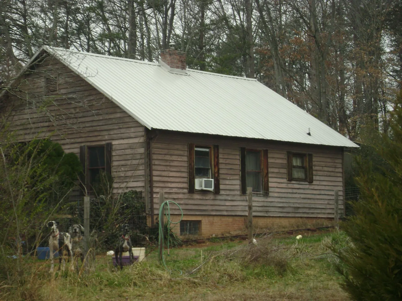 White metal roof on an old wood sided farmhouse, from a Metal Roof Installation job in Hope Valley